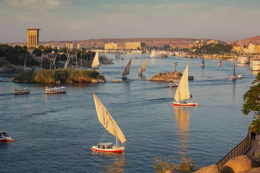 Beautiful panorama landscape with felucca boats on Nile river in Aswan at sunset, Egypt