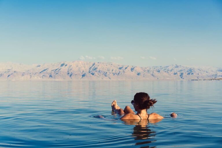 Girl is relaxing and swimming in the water of the Dead Sea