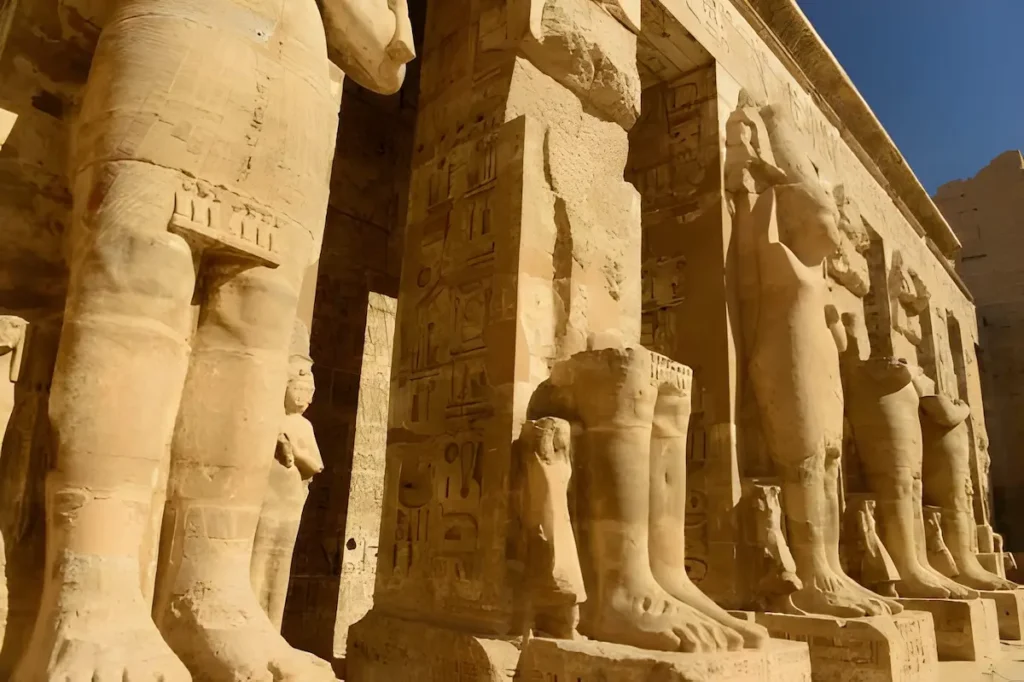 The first courtyard lined with colossal pharaoh statues.