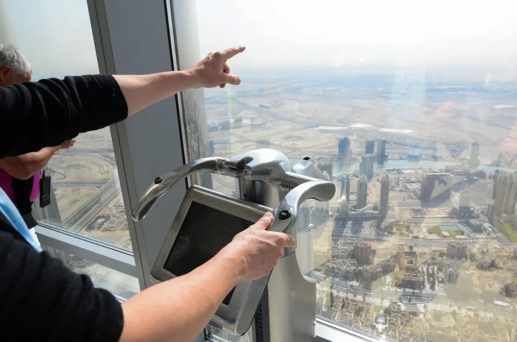 A man using an electronic telescope at the top of Dubai's Burj Khalifa, the world's tallest building.
