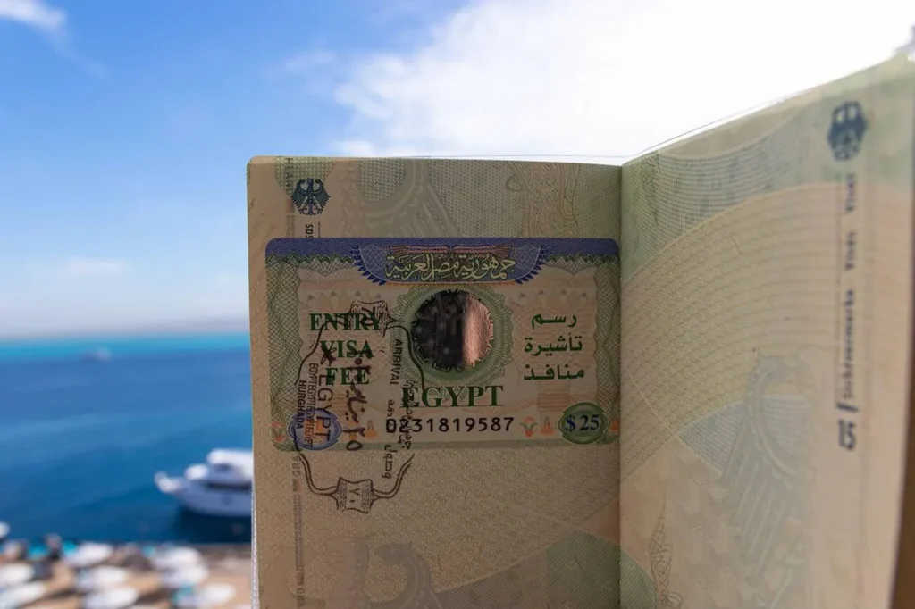 Visa Of The Arab Republic Of Egypt In A Passport Of The Federal Republic Of Germany With A Blurred Vacation Background