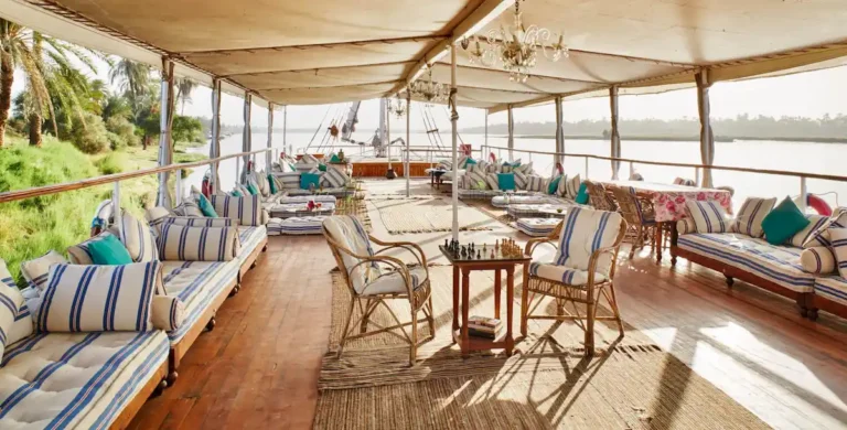Spacious Dahabiya Nile cruise deck with shaded seating and river views