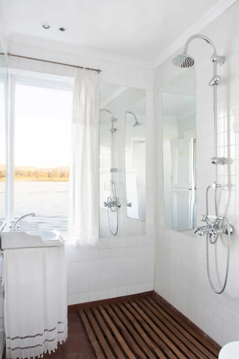 Private Dahabiya bathroom with a rainfall shower and Nile River view