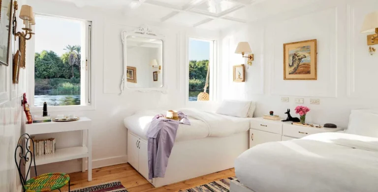 Bright twin cabin aboard a Dahabiya Nile cruise with views of the Nile