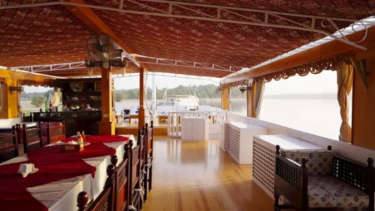 Shaded outdoor dining area aboard Amoura Dahabiya