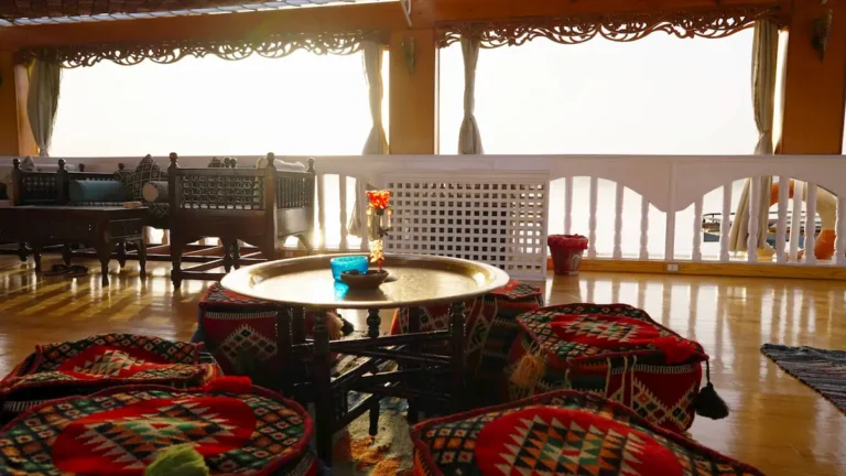 Traditional Egyptian seating area with a brass table aboard Amoura Dahabiya
