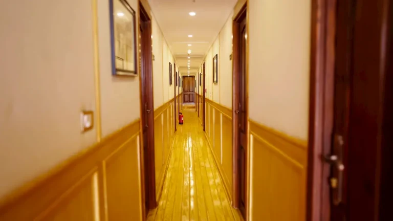Polished wooden corridor leading to guest cabins aboard Amoura Dahabiya