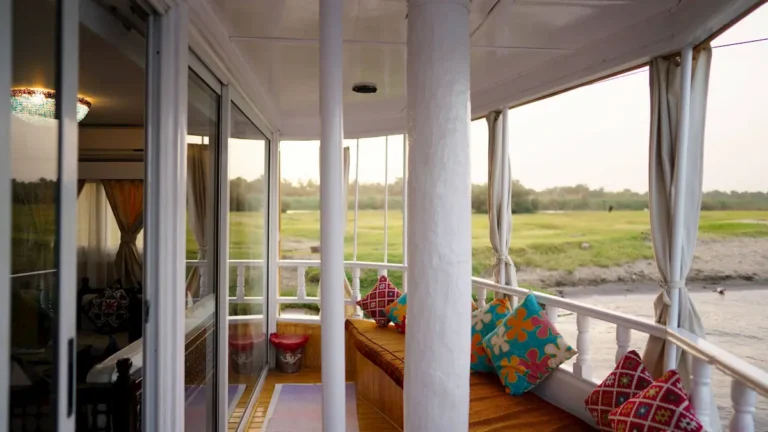 Covered private deck with colorful cushions overlooking the Nile