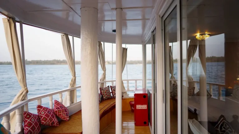Cushioned outdoor seating area aboard Amoura Dahabiya with Nile views