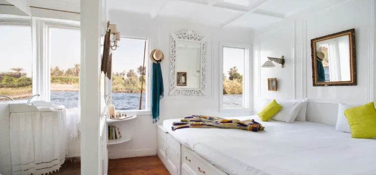 Bright Dahabiya cabin with a double bed, private bathroom and Nile views