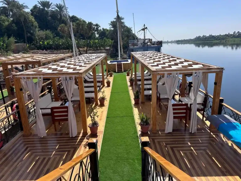 Renovated Merit I Dahabiya sun deck with shaded seating and Nile views