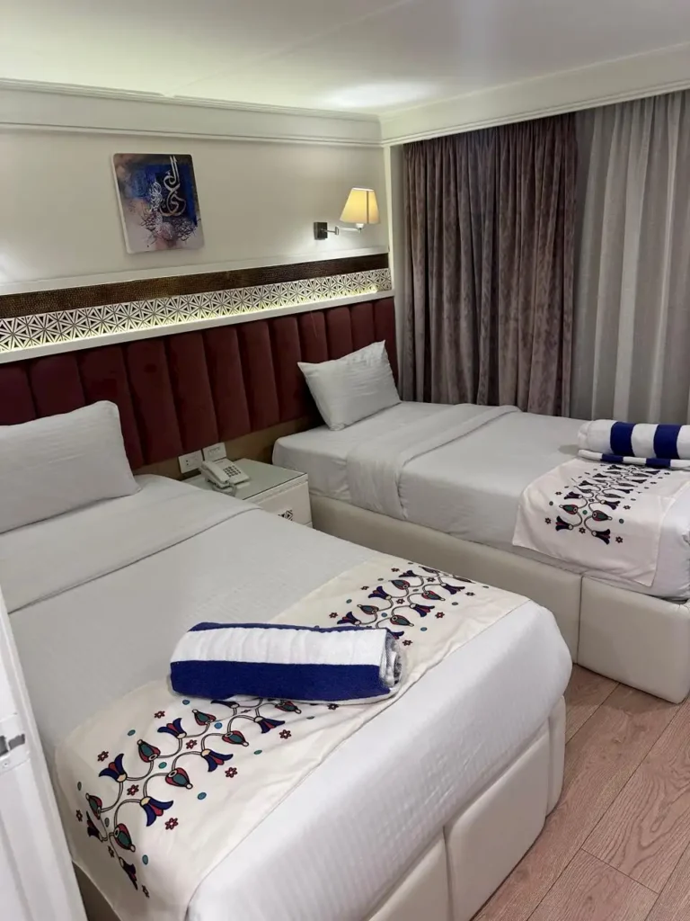 Merit I Dahabiya twin cabin with two beds and embroidered Egyptian bedding