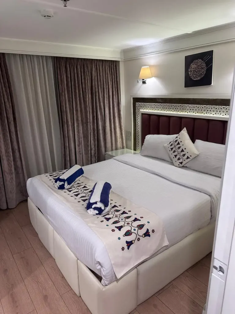 Merit I Dahabiya king-bed cabin with embroidered bedding and folded towels